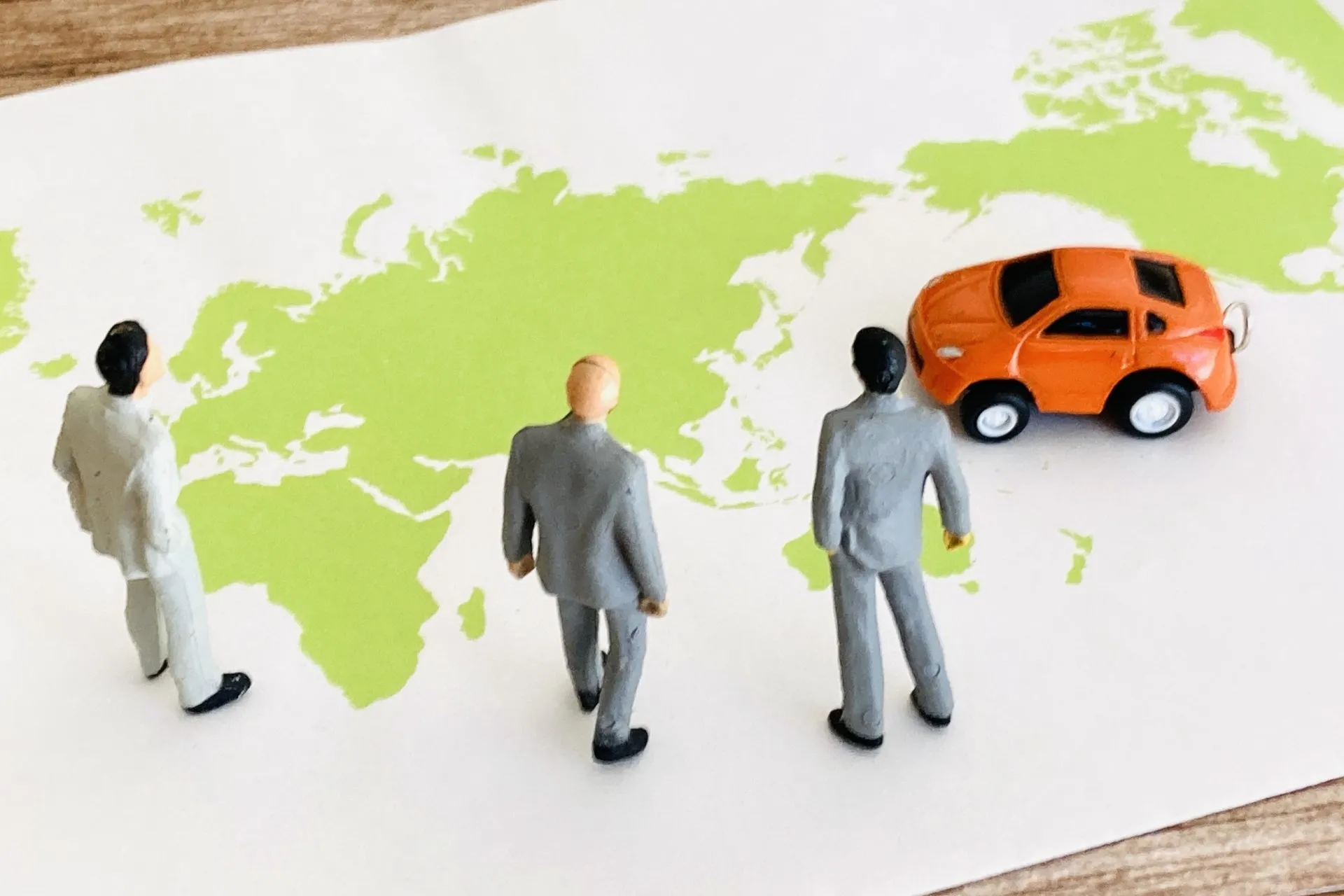 世界地図とビジネスパーソンと車